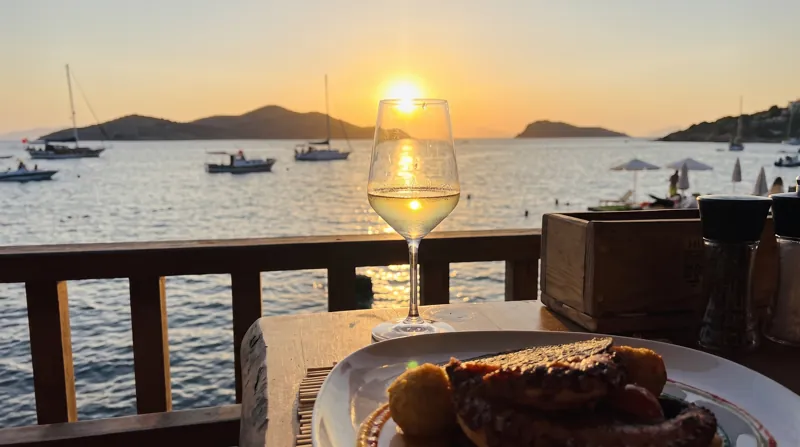 Sunset over the bay, seen from a table on the terrace