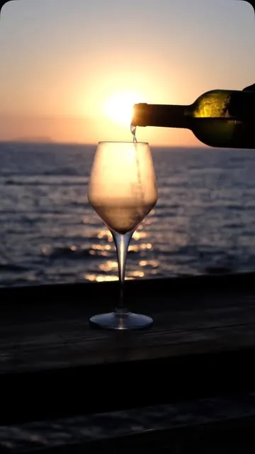 Wine poured against the sunset on the terrace